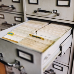 Open file cabinet drawer full of documents