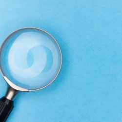 a magnifying glass against a blue background