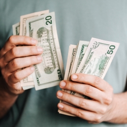 Man handling 20 and 50 dollar bills