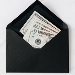 20 dollar bills inside black envelope