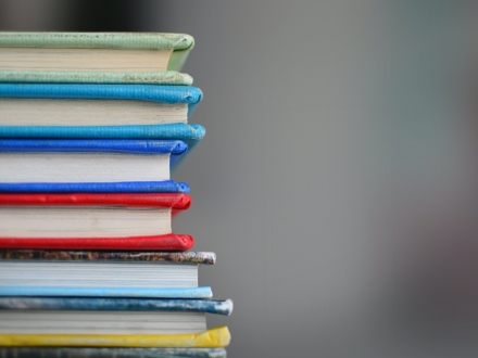 stack of worn down colored textbooks